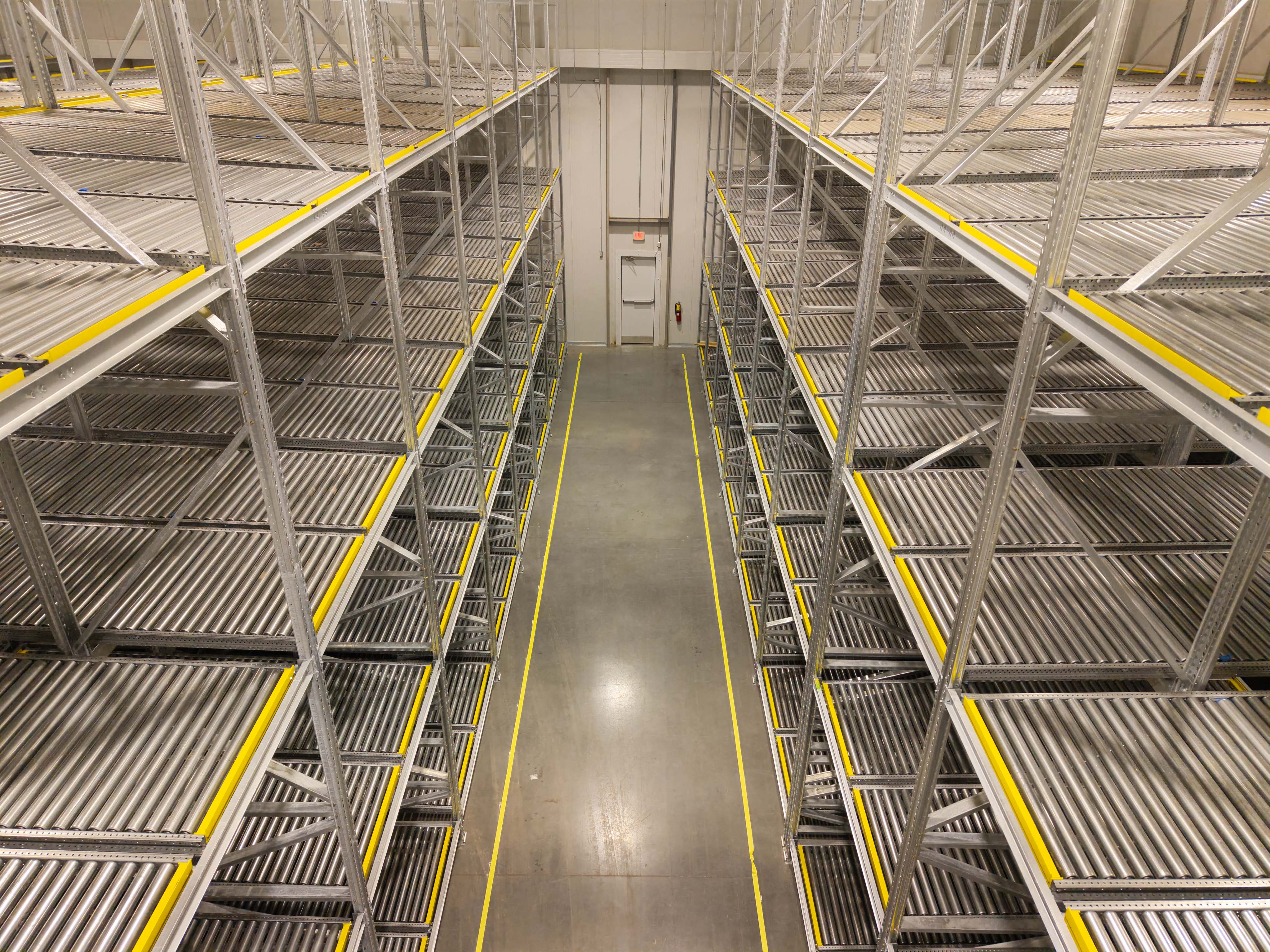 High-bay cold storage rack system with organized lanes and controlled infrastructure.